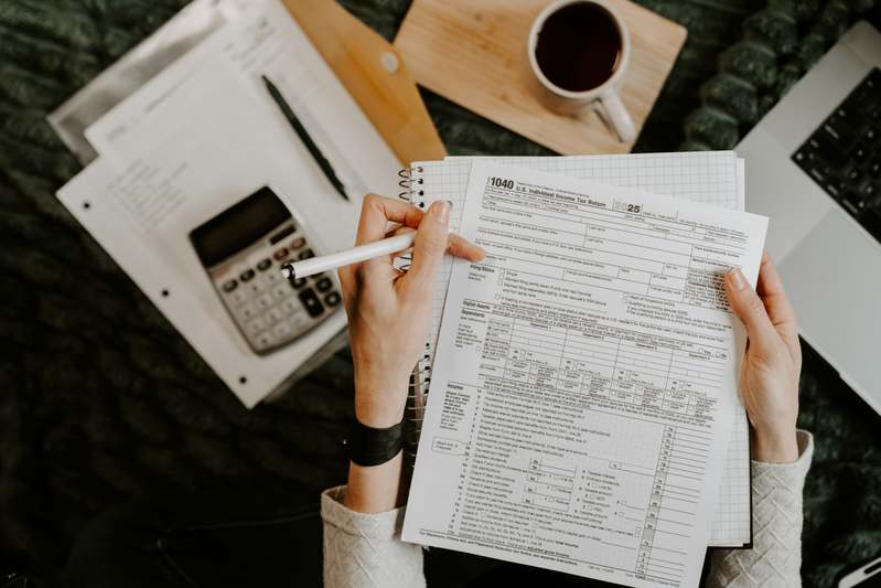 Group of diverse professionals learning audit techniques with laptops and financial dashboards